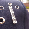 Blessed theme custom cap showing blessed metal tag up-close